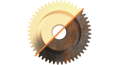 A gear with a line dividing it in half, one side showing a plastic gear and the other showing a corroded metal gear