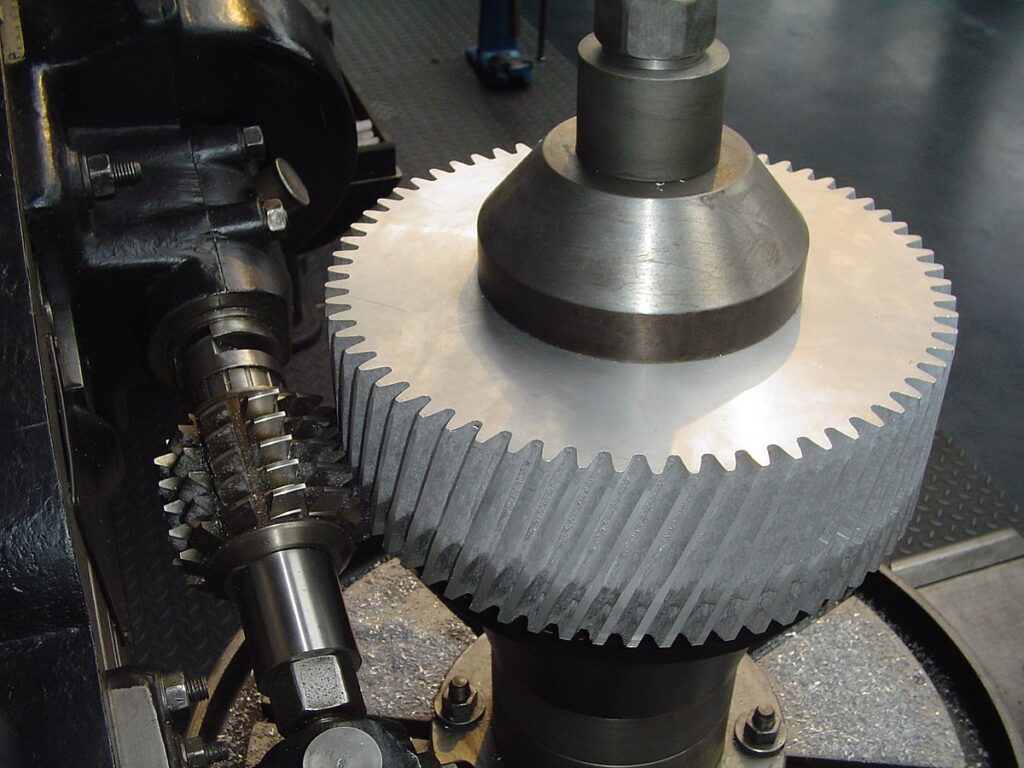 Gear hob in the middle of machining a helical gear